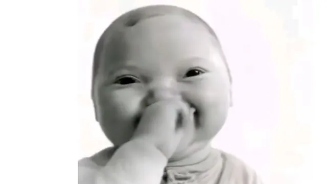AI Baby Holding Laugh meme card