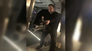Elon Musk Holding a Minigun meme card, common rarity