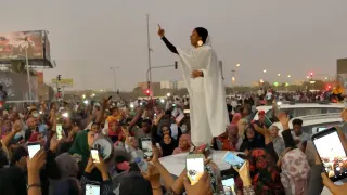 Protesting Sudanese Woman Standing on Car meme card, common rarity